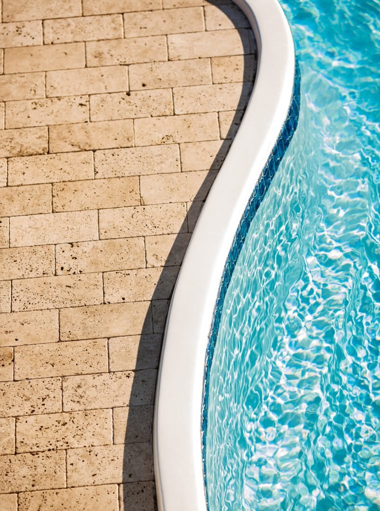 Beautiful view of stone tiles and swimming pool. Copy space.