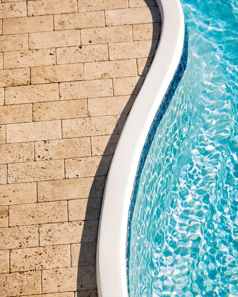 Beautiful view of stone tiles and swimming pool. Copy space.